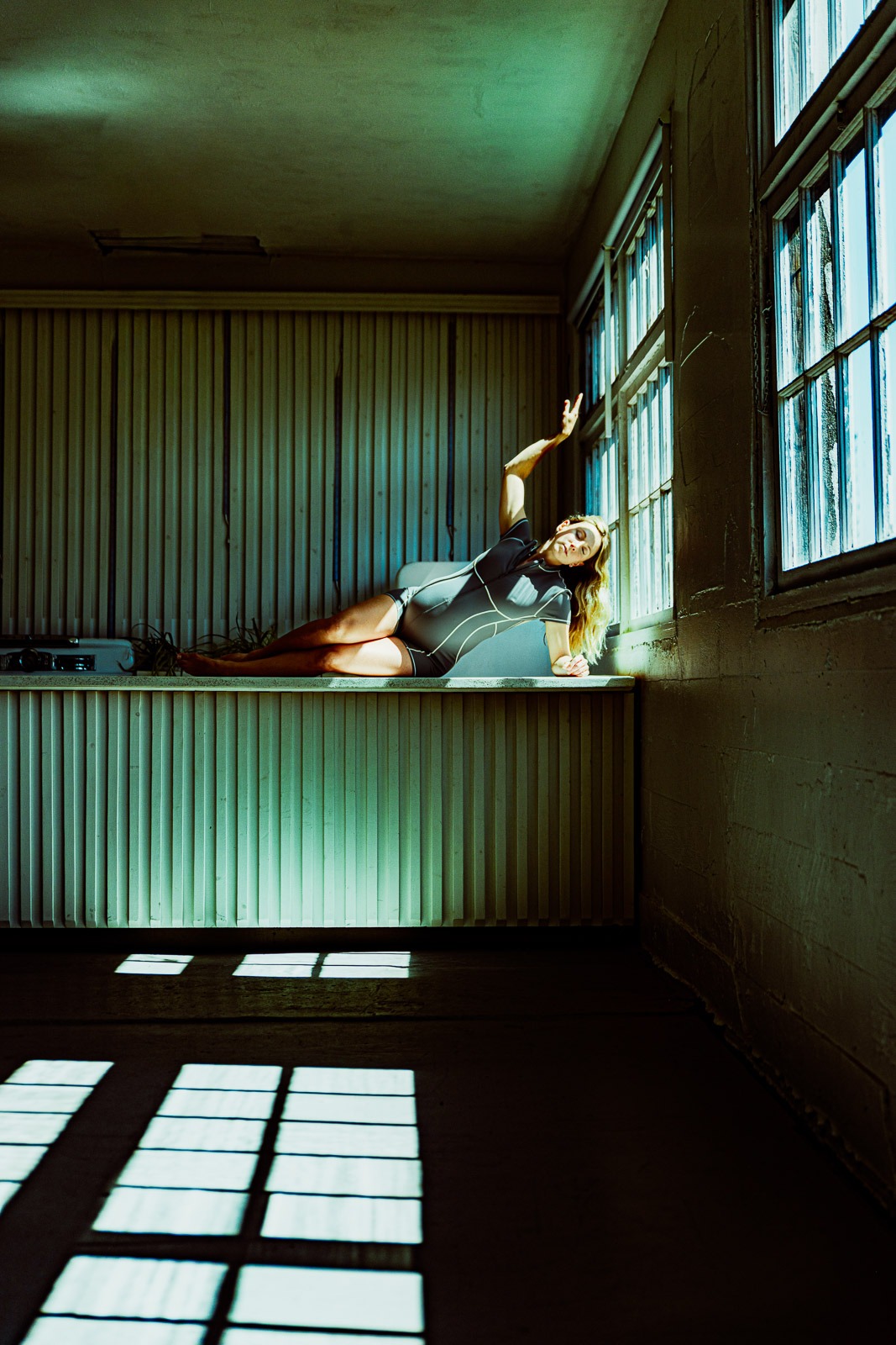 Cinematic Editorial Photographer Pregnant woman in shadow bathed in sunlight - Pelvic Floor specialist and Physio Therapist
