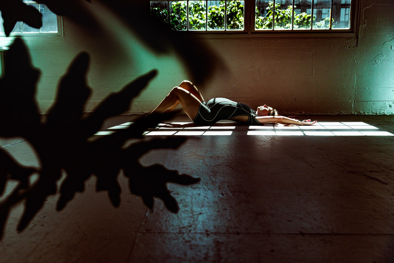Cinematic Editorial Photographer Pregnant woman in shadow bathed in sunlight